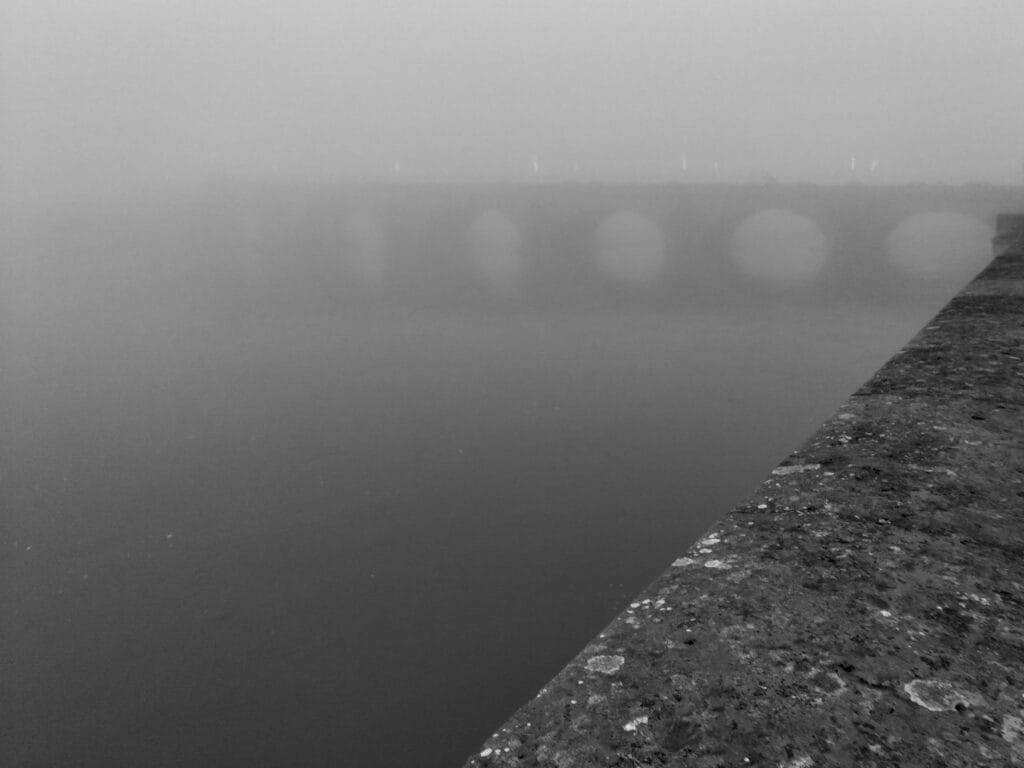 A view of the bridge at Blois shrouded in thick mist.