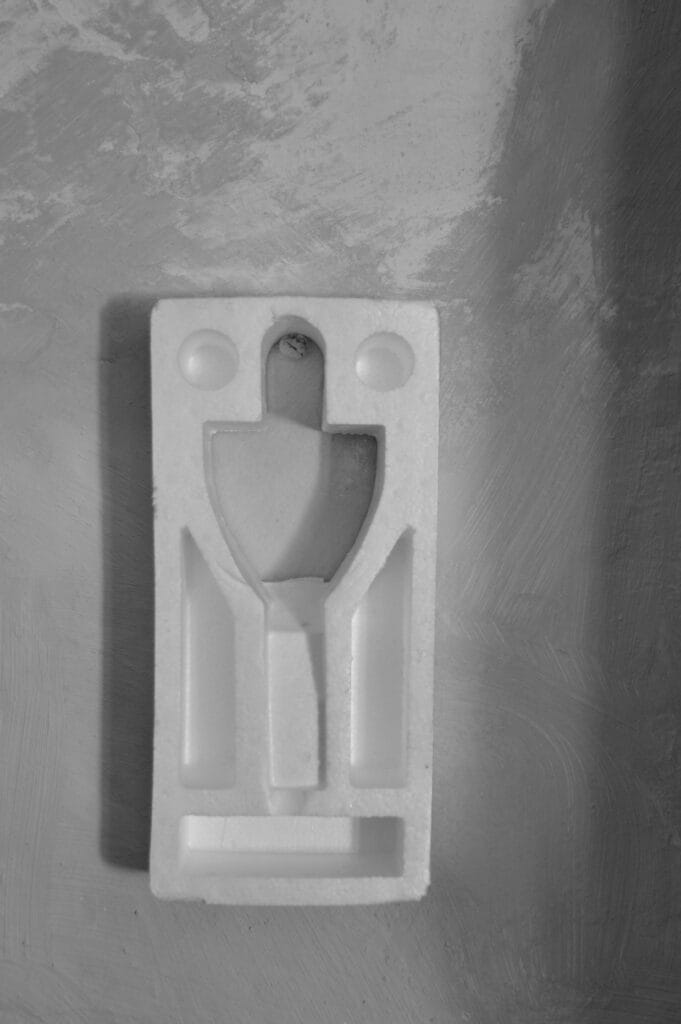 A polystyrene package cushioning section is displayed on a wall as if it were an artwork.