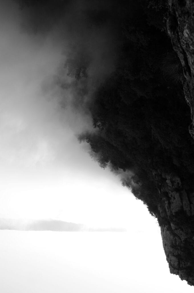 Mountain side catching valley clouds.