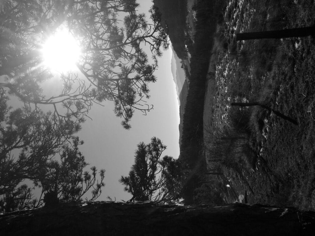 A path offering views of the valleys and mountains in the distance.