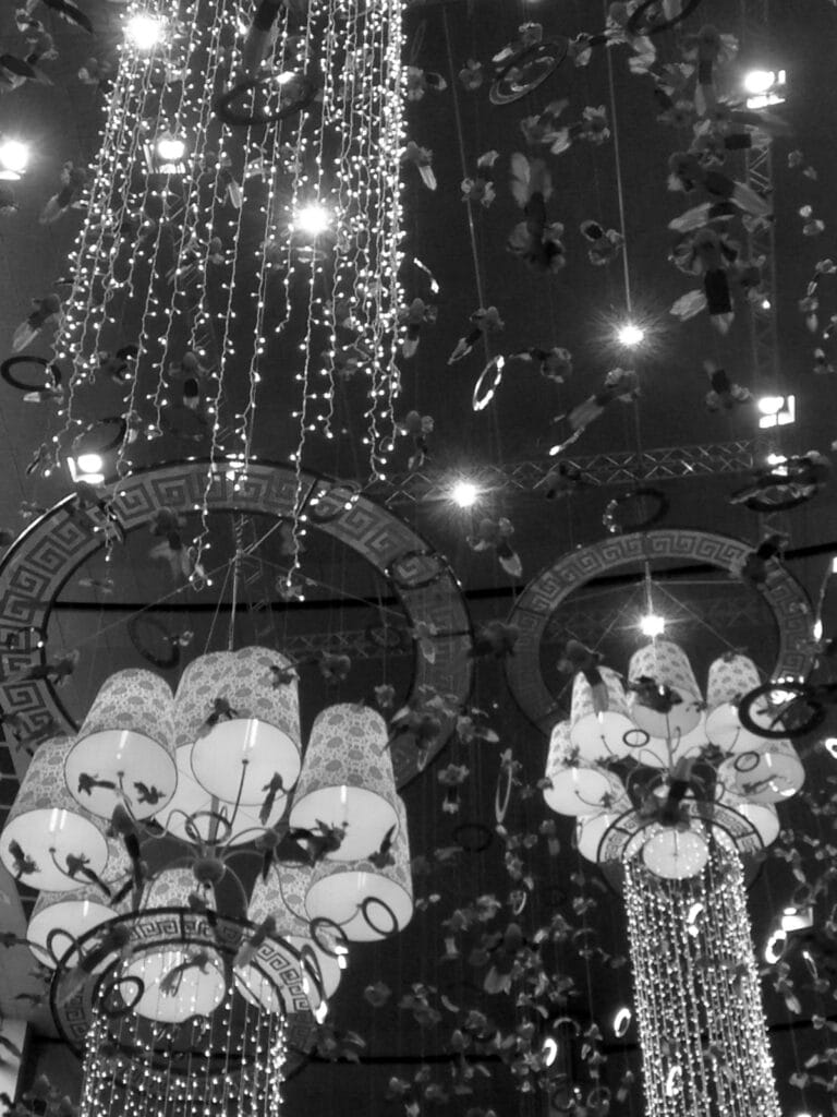 Chinese New Year decorations, including chandeliers, light garlands and hanging birds.