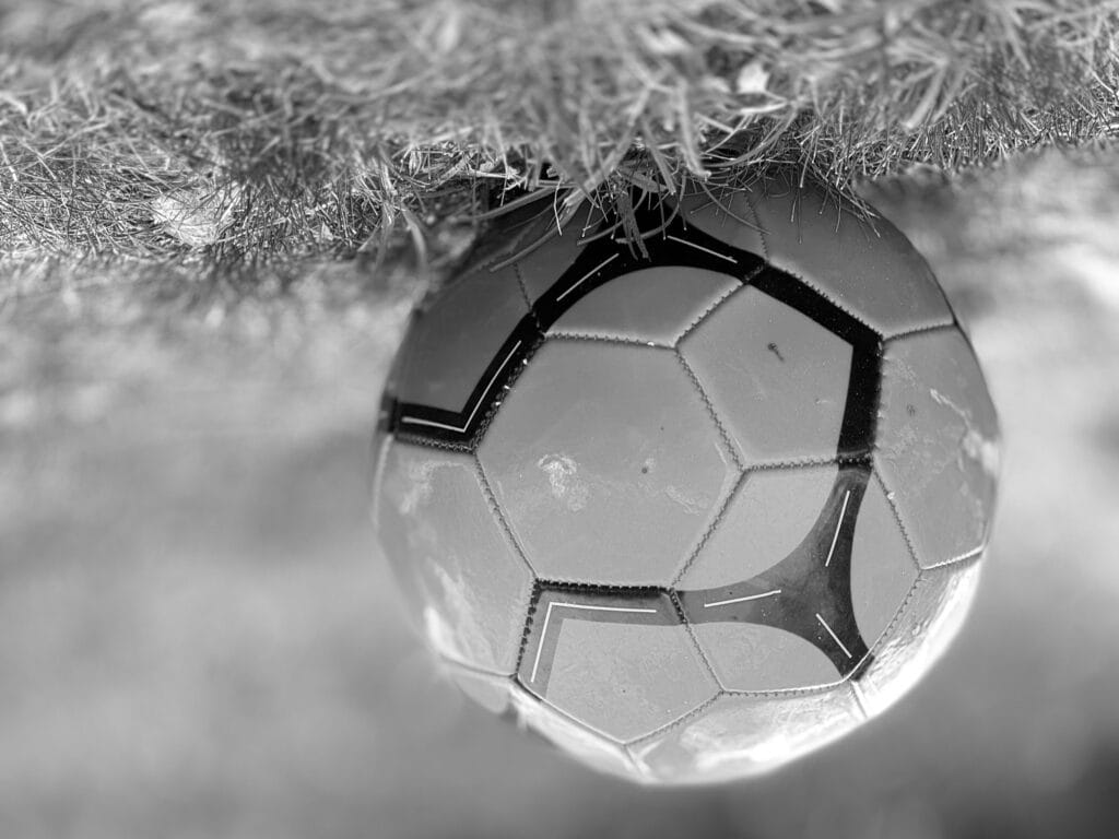 Football on a lawn. The image is upside down: the ball is suspended on the lawn.