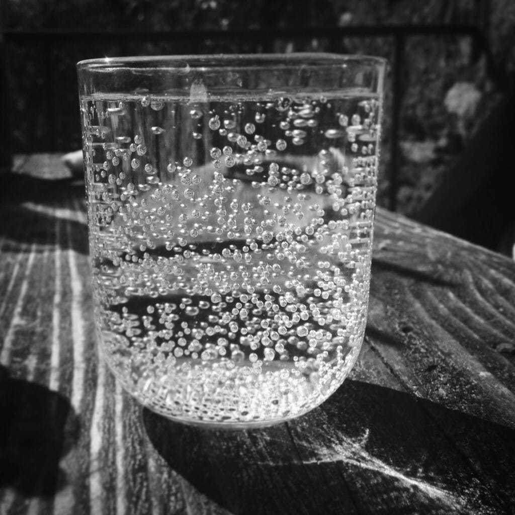 Glass of sparkling water on a table.