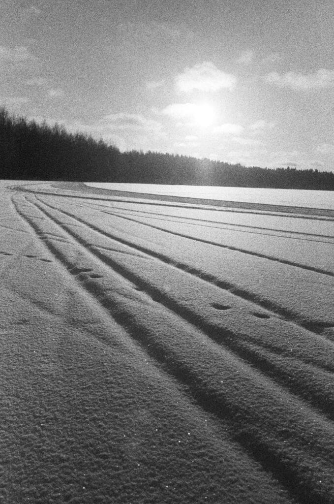 Ski tracks in the snow on the sea in winter.