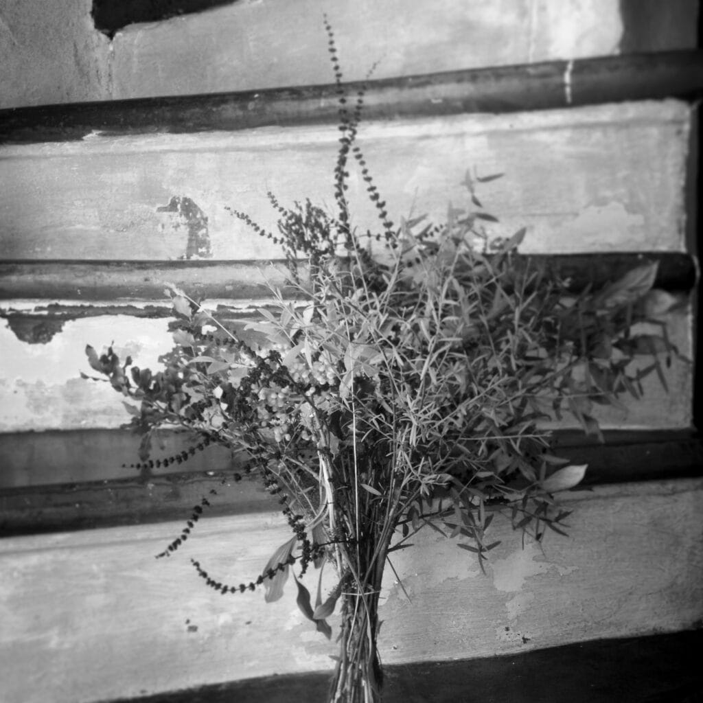 A bouquet placed on the steps of a staircase.
