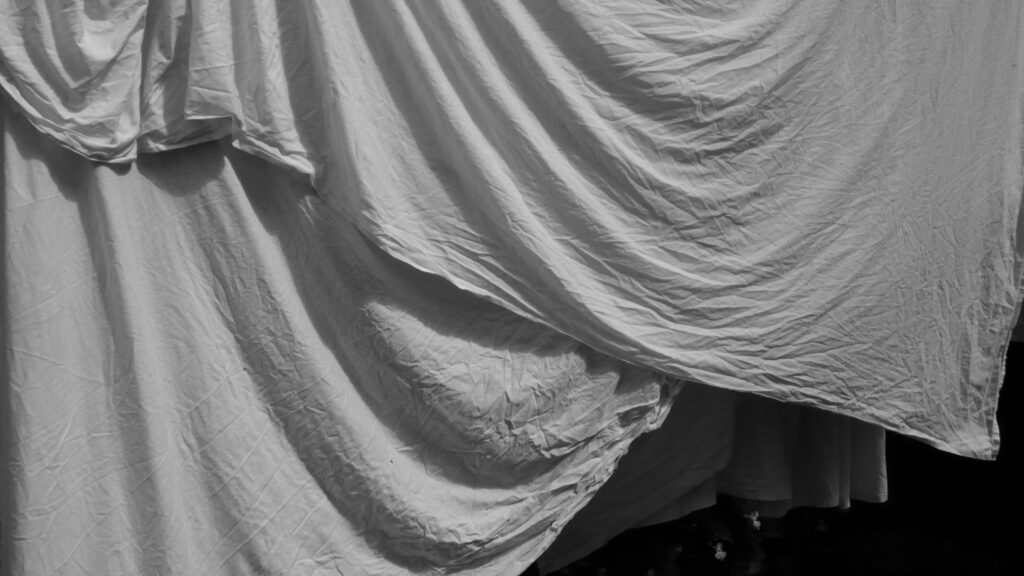 Sheets drapery over the clothesline.