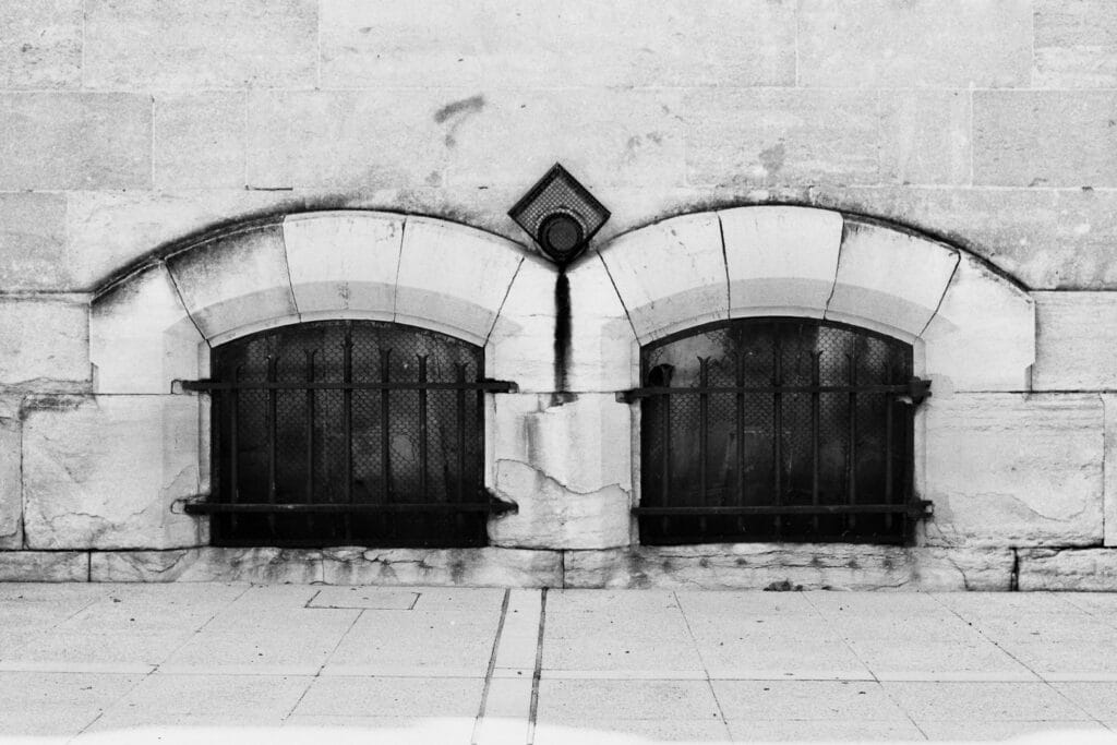 Two identical basement windows side by side.