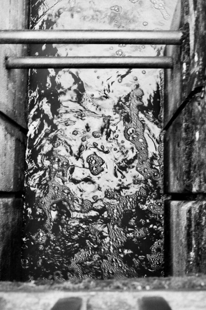 A whirlpool of water between two pillars of a dam.