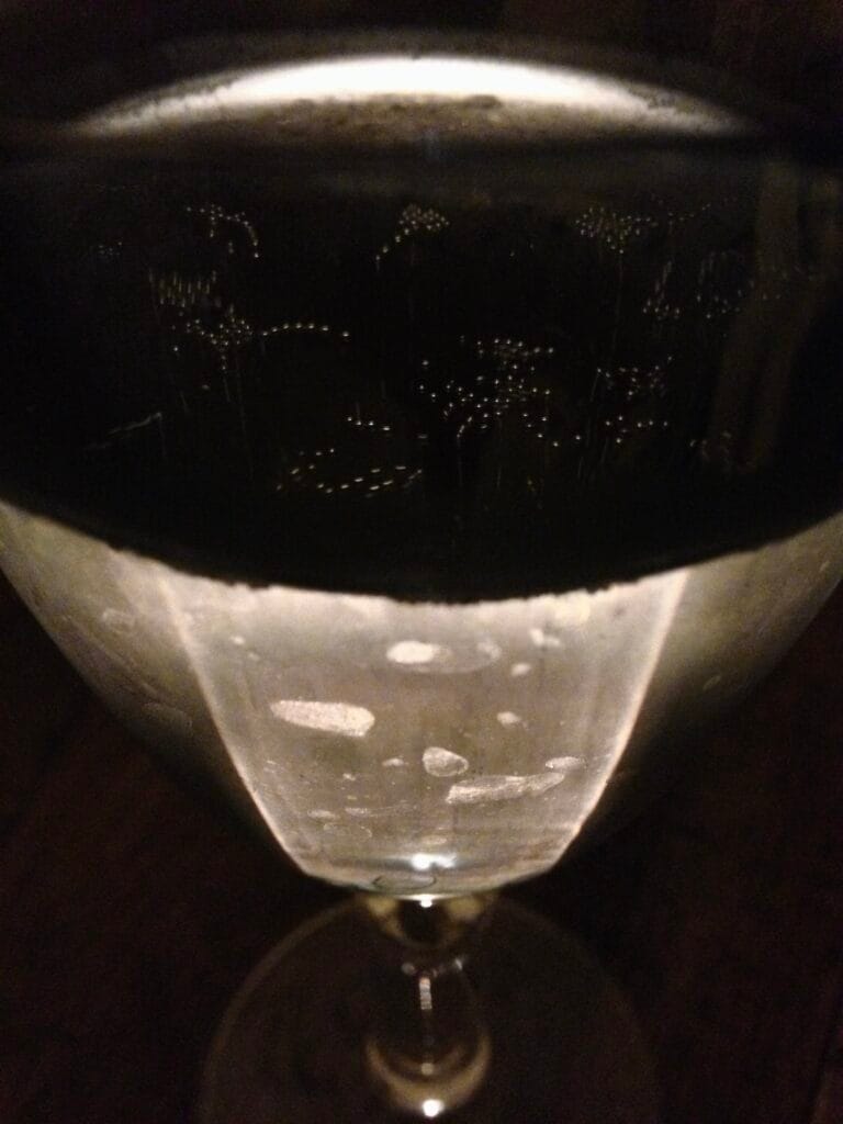 A champagne glass lit from behind and photographed from above.