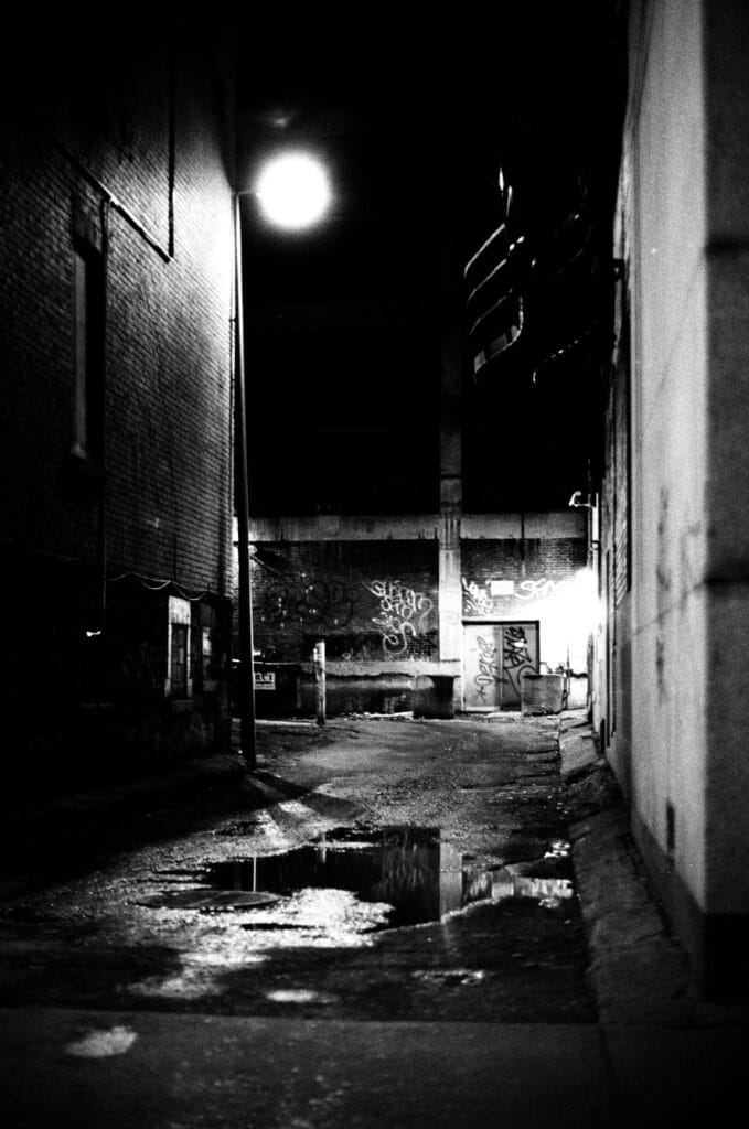 A gloomy side street at night.