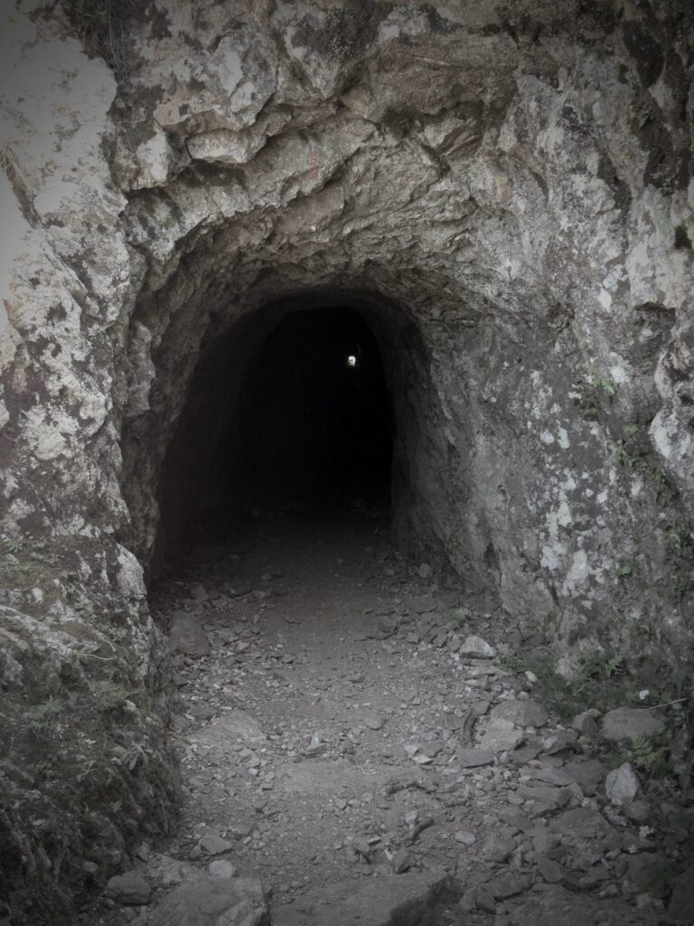 A narrow tunnel carved out of the rock.