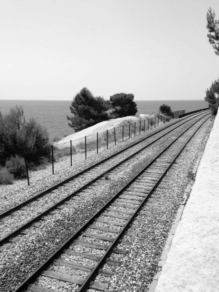 A railway line that runs along the cliff by the sea.